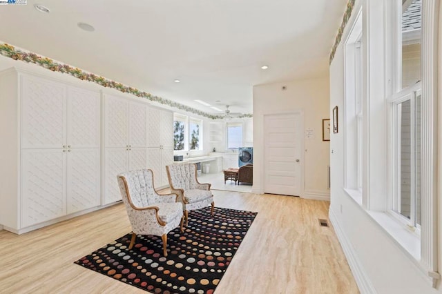 sitting room with light hardwood / wood-style floors