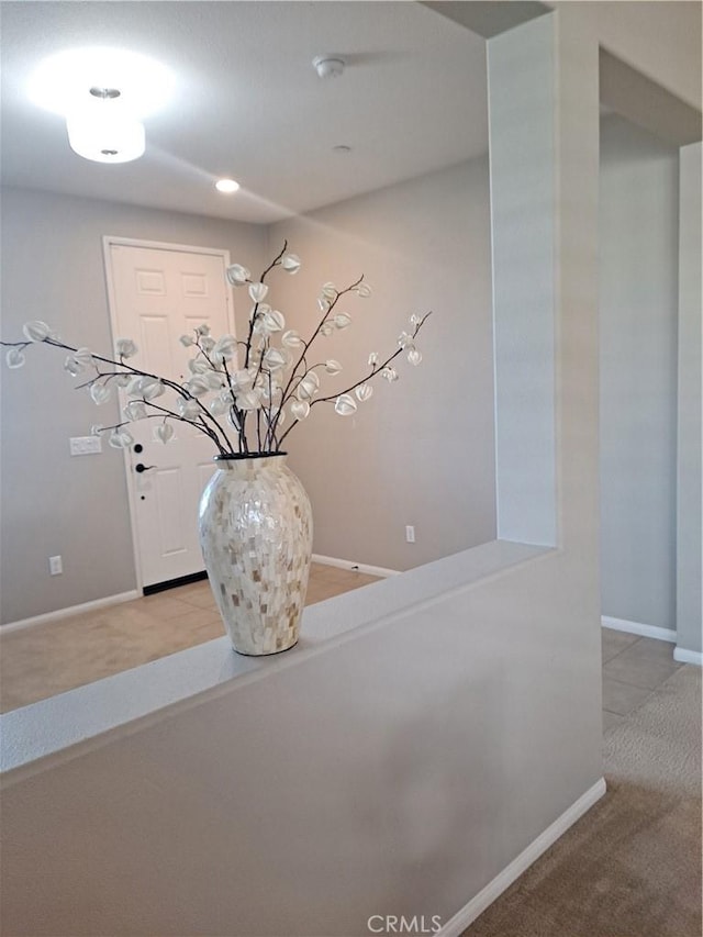 interior space featuring carpet floors and baseboards