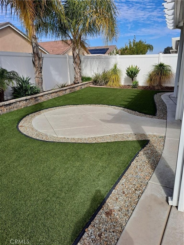 view of yard with a fenced backyard and a patio