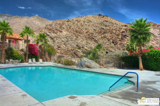 view of swimming pool featuring a mountain view and a patio area