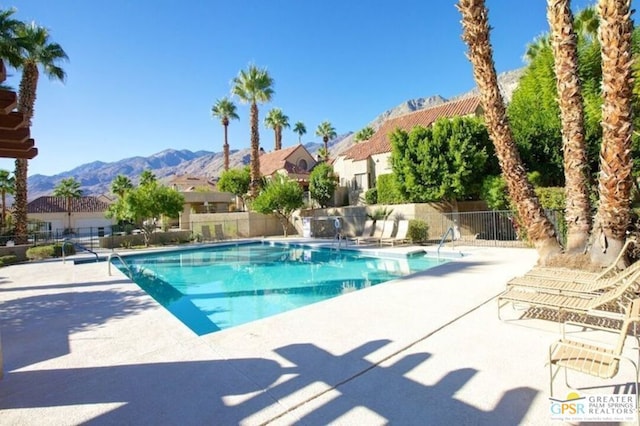 view of swimming pool featuring a mountain view and a patio area