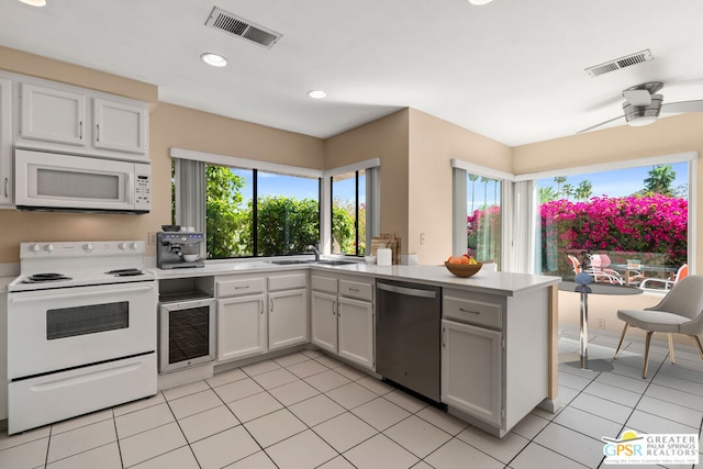 kitchen featuring white appliances, sink, wine cooler, ceiling fan, and white cabinetry