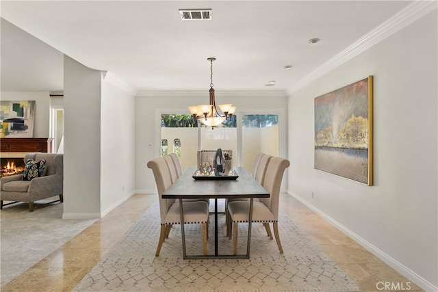 dining area featuring crown molding and an inviting chandelier