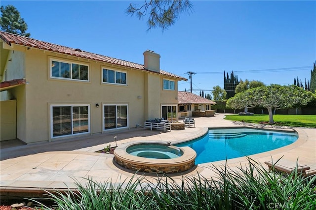 view of pool with a patio area and an in ground hot tub