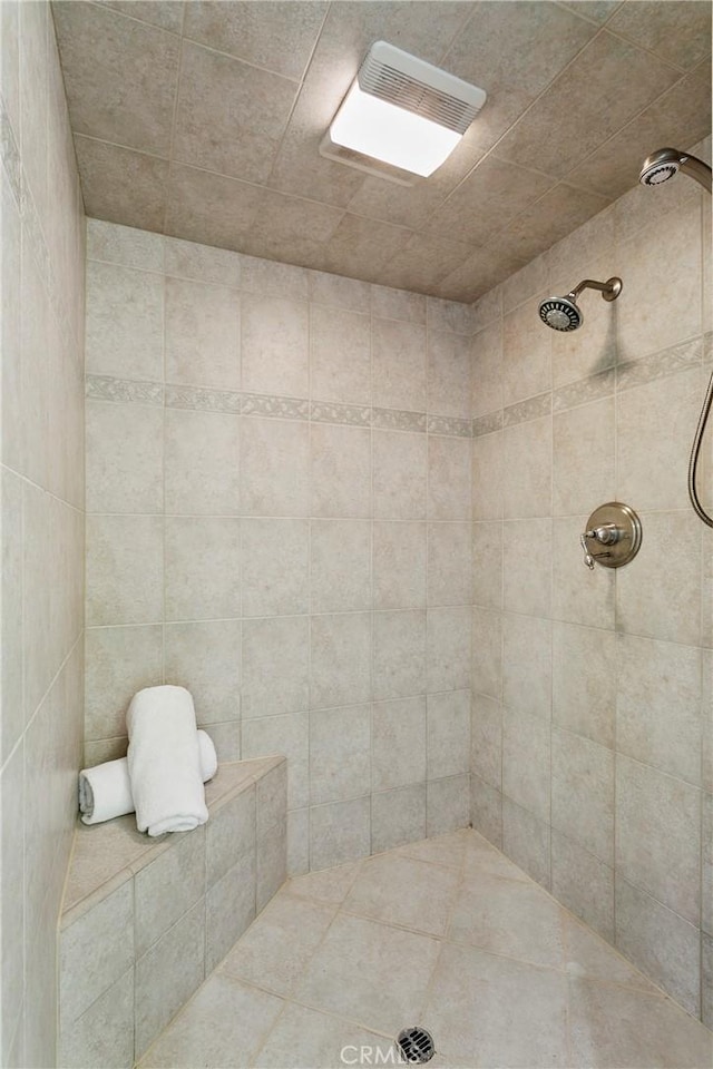 bathroom with tiled shower