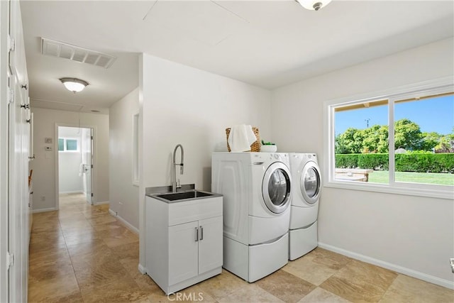 laundry room with cabinets, sink, and washing machine and clothes dryer