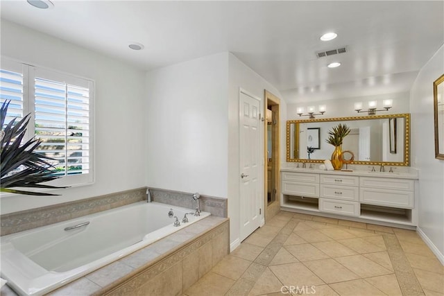 bathroom with vanity, tiled bath, and tile patterned floors