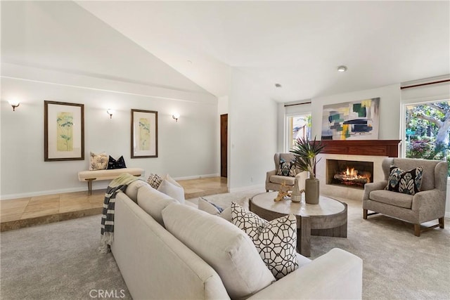 living room with a healthy amount of sunlight, light tile patterned floors, and high vaulted ceiling