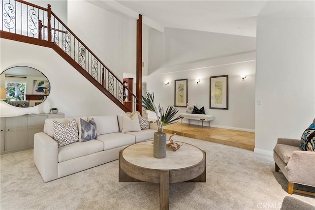 living room with light carpet and high vaulted ceiling