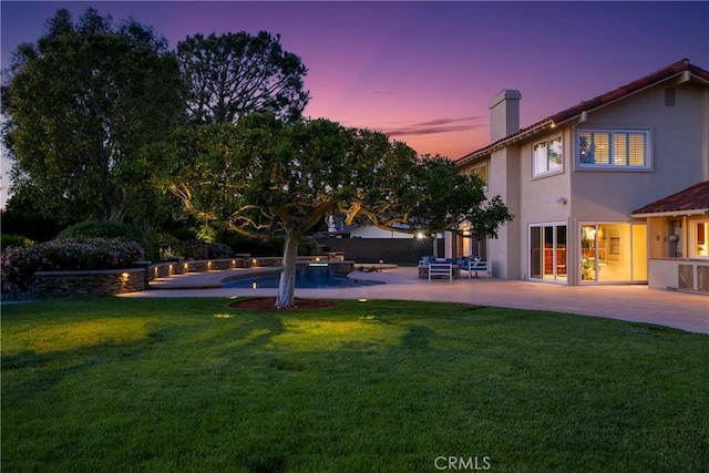 yard at dusk with a patio