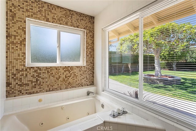 bathroom featuring plenty of natural light and tiled tub