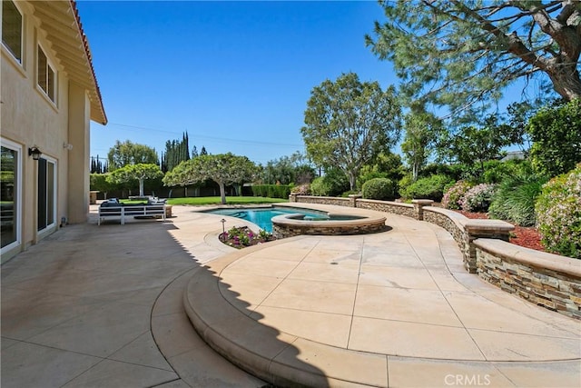 view of swimming pool with an in ground hot tub and a patio