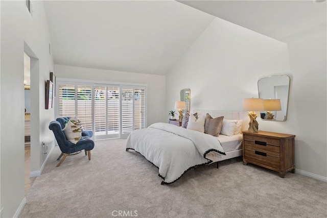 bedroom with light carpet and high vaulted ceiling