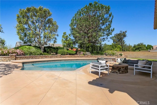 view of pool featuring a patio and an outdoor fire pit