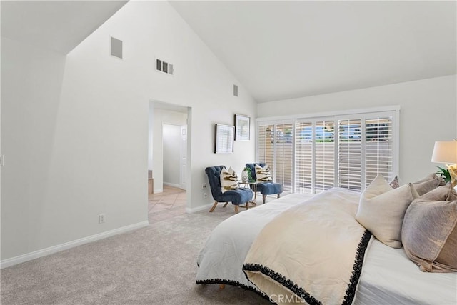 carpeted bedroom featuring high vaulted ceiling