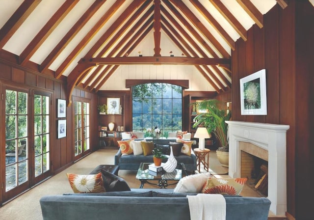 carpeted living room with beam ceiling, high vaulted ceiling, a wealth of natural light, and wooden walls