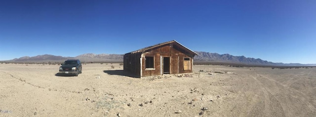 view of outdoor structure featuring a mountain view and a rural view