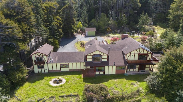 drone / aerial view featuring a wooded view