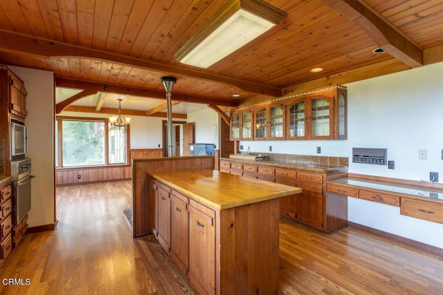 kitchen featuring a chandelier, wood ceiling, wood finished floors, and stainless steel appliances