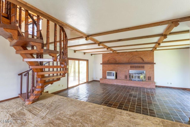 unfurnished living room featuring a fireplace, baseboards, and beamed ceiling