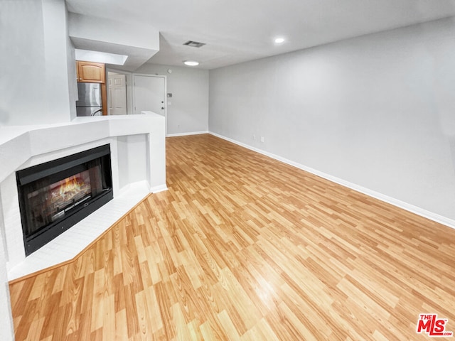 unfurnished living room with light hardwood / wood-style flooring