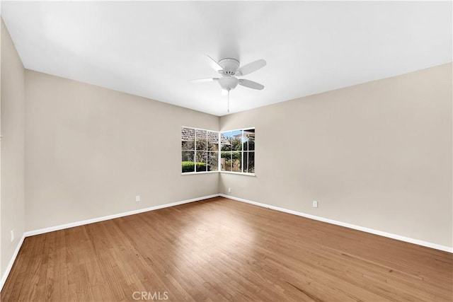 unfurnished room with hardwood / wood-style flooring and ceiling fan