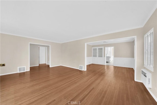 spare room with crown molding and dark wood-type flooring