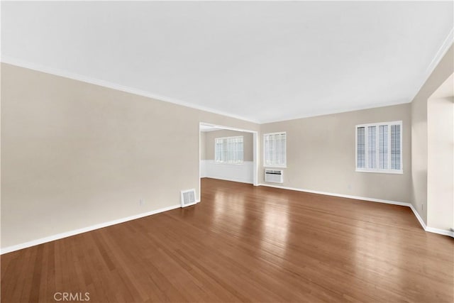 spare room featuring ornamental molding and hardwood / wood-style floors