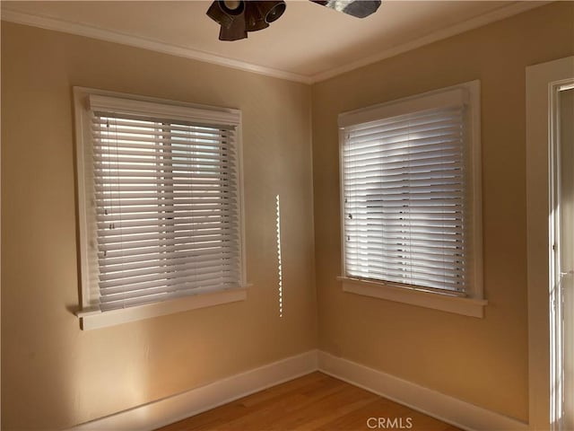 spare room with crown molding, wood-type flooring, and ceiling fan