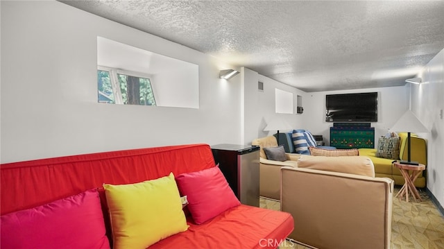 carpeted living room featuring a textured ceiling