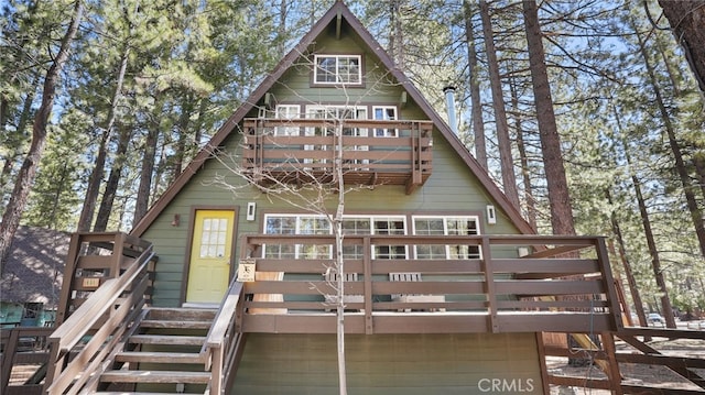 rear view of property featuring a balcony