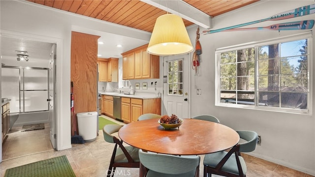 kitchen with beam ceiling, dishwasher, pendant lighting, light tile patterned floors, and wood ceiling