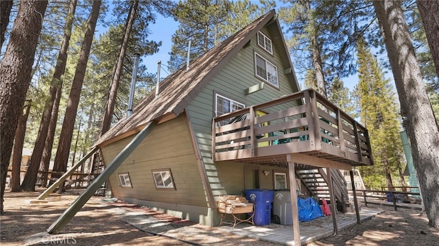 back of property with a wooden deck