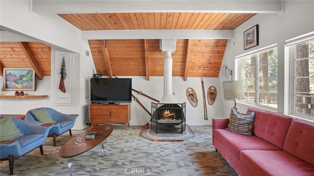 living room featuring beamed ceiling, a wood stove, and wooden ceiling