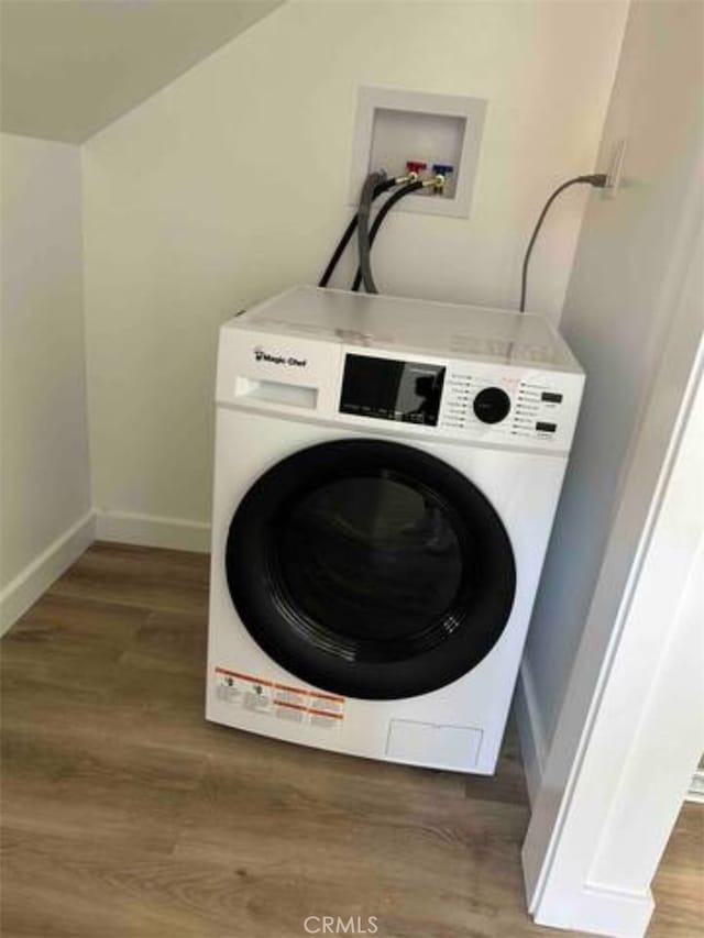 laundry area with dark wood-type flooring and washer / clothes dryer