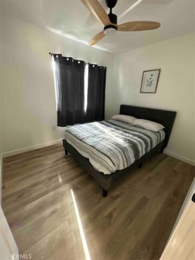 bedroom featuring ceiling fan and wood-type flooring