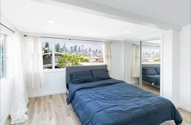 bedroom with a closet and light wood-type flooring