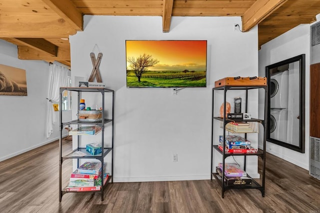 game room with beamed ceiling, wooden ceiling, hardwood / wood-style floors, and stacked washer and clothes dryer