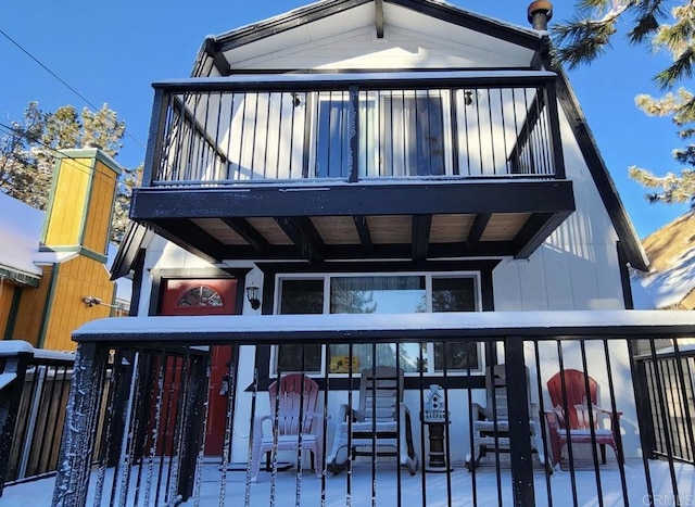 back of property featuring a balcony