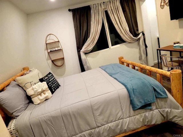 bedroom with wood-type flooring