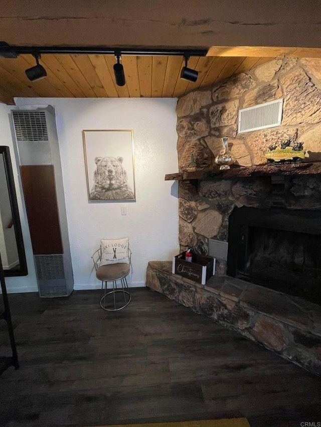 living room with dark hardwood / wood-style floors, a fireplace, wooden ceiling, and rail lighting