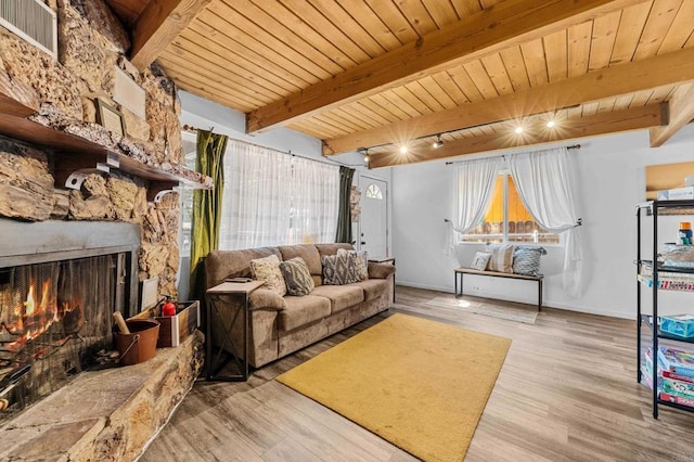 living room with beam ceiling, wooden ceiling, a fireplace, and light hardwood / wood-style flooring