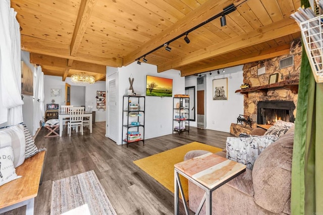 living room with hardwood / wood-style floors, beam ceiling, and track lighting