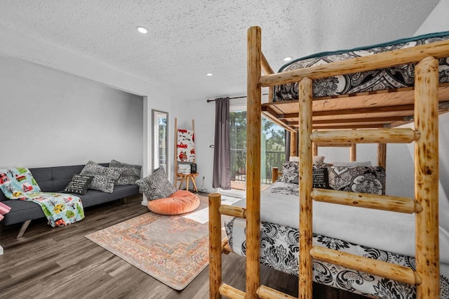 bedroom with wood-type flooring and a textured ceiling