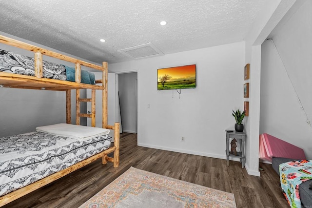 bedroom featuring dark hardwood / wood-style flooring and a textured ceiling