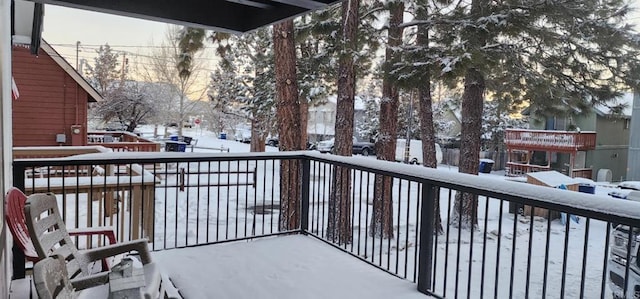 view of snow covered back of property