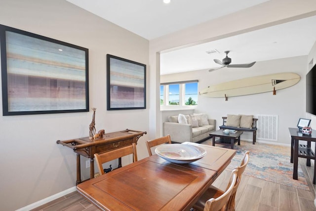 dining room featuring ceiling fan and wood-type flooring