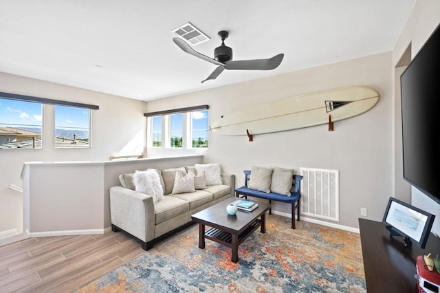 living room featuring ceiling fan and light hardwood / wood-style flooring