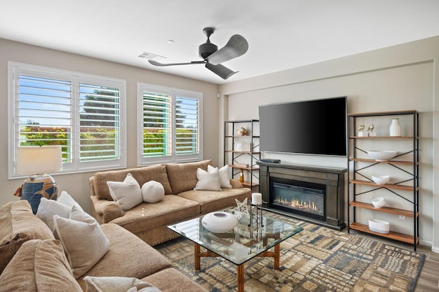 living room featuring hardwood / wood-style floors and ceiling fan