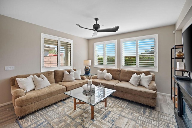 living room featuring hardwood / wood-style floors and ceiling fan